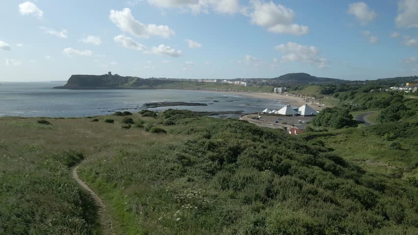 Aerial view of North bay, Scarborough, North Yorkshire with grassland, ocean, and castle