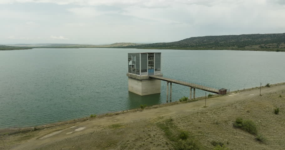 Desolate control tower and bridge in Dali Mta lake reservoir, Georgia.