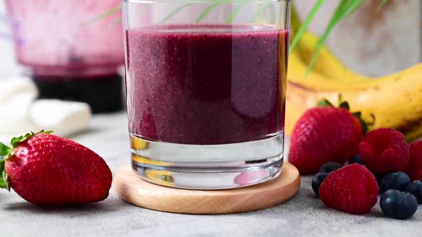Berry smoothie in a glass. Strawberry, banana, blueberry thick smoothie.