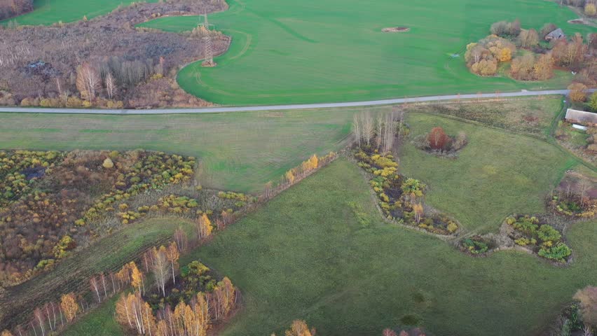 October time farmland fields and groves in nature park, aerial view