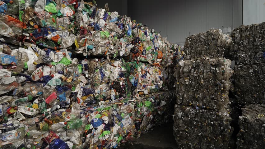 Garbage Recycling Factory, Plastic cubes for recycle Plant, Bales of pressed boxes, rubbish warehouse collection. Preparation of recyclables for recycling, Plastic city garbage. | Shutterstock HD Video #1100214863