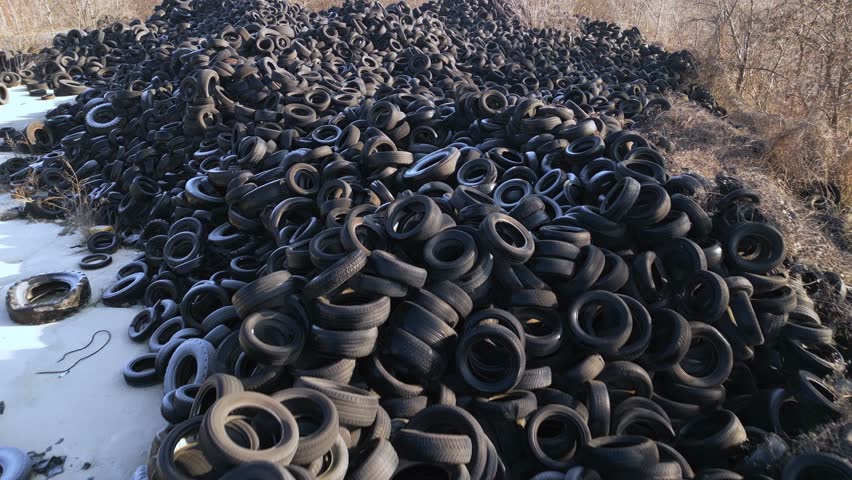 Aerial view of old tires dump. Many car and truck tires on dump site from above Royalty-Free Stock Footage #1100215933