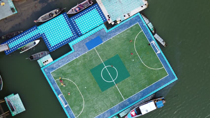 Floating soccer field, Koh Panyee fishing village in Thailand. Sport and recreation concept. Aerial view. | Shutterstock HD Video #1100217795