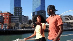 Young african american women in the city, lifestyle couple concept, walking laughing by the river