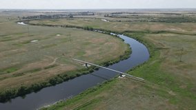 A gas pipeline across the river. Video footage from above from a flying drone. Kazakhstan, Ural river. High quality 4k footage with slow motion