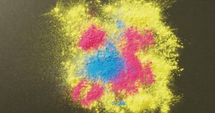 Video of multi coloured powders with copy space on black background. Holi festival, hindu tradition and celebration concept