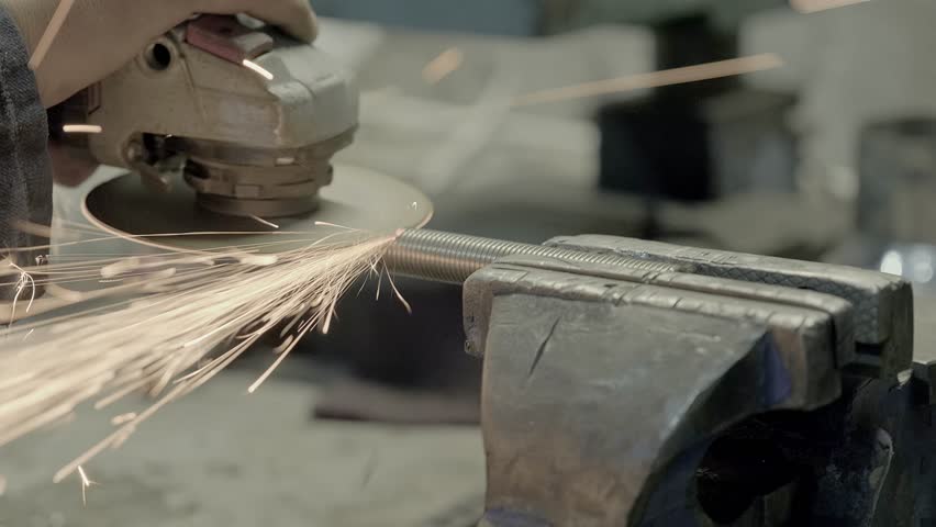 Man using electric circular saw industrial cutting machine blade at factory. sparks fly. circular saw spinning on metal parts production machine. slow motion | Shutterstock HD Video #1100227231