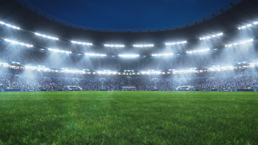 Aesthetic Tracking Establishing Shot of Big and Empty Soccer Football Stadium With Crowd Of Fans Cheering in Excitement Before the Match. Lights Are Shining on The Sports Arena Grass Field. | Shutterstock HD Video #1100228997