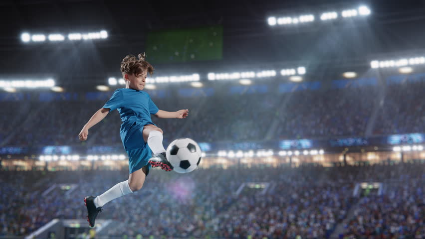 Aesthetic Shot Of Athletic Child Soccer Football Player Jumping And Kicking Ball Mid-Air On Stadium WIth Crowd Cheering. Super Slow Motion Captures A Boy Scoring a Goal on Junior World Championship. | Shutterstock HD Video #1100228999