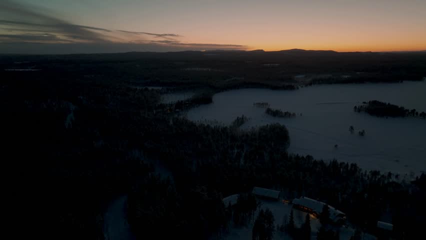Shot of Oulanka National Park in the heart of Finnish Lapland winter. The river with the Myllykoski rapids and the famous watermill. Sunset in the rocky gorges. River rapids with frozen trees.