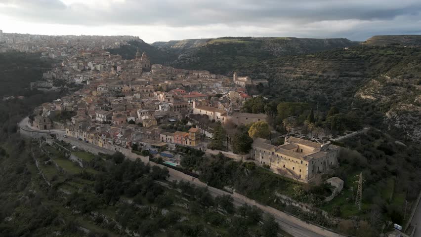 Aerial view of Ragusa Ibla, a medieval town on the hillside with Ibleo Garden in foreground at sunset in Sicily, Italy.