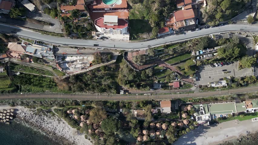 Aerial view of a road along the coastline near Isola Bella, Taormina, Messina, Sicily, Italy.