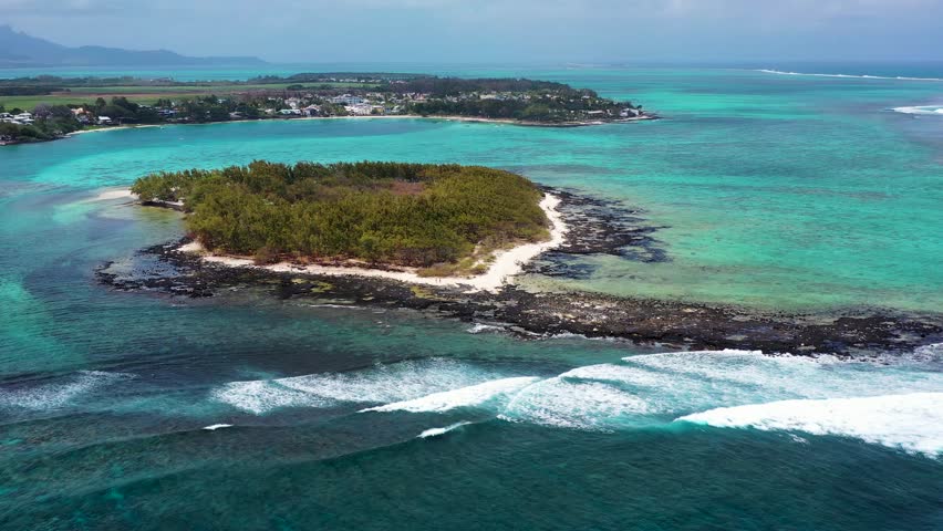 Aerial view of a small island along the coastline on Blue Bay, Mauritius.