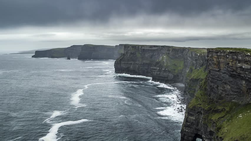 Aerial view of Cliffs of Moher long coastline at sunset with cloudy sky, Lislorkan North, Clare, Ireland. Royalty-Free Stock Footage #1100230259
