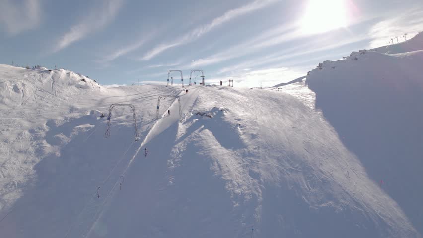 Aerial drone footage of Whistler mountain, BC, ski hill on a sunny day, chairlift, Whistler peak, ski run, skier, winter sport. 5.4K 24FPS