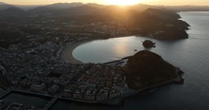 Sunset drone view above Donostia San Sebastián coastal city in Basque Country, Spain.