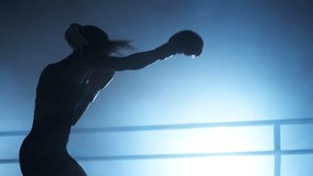 Portrait of slim woman training to build strong muscles and toned body. Close-up shot of active woman in boxing gloves warming up before a sparring in the ring. High quality 4k footage - Powered by Shutterstock - Get 15% off with code: PIKWIZARD15