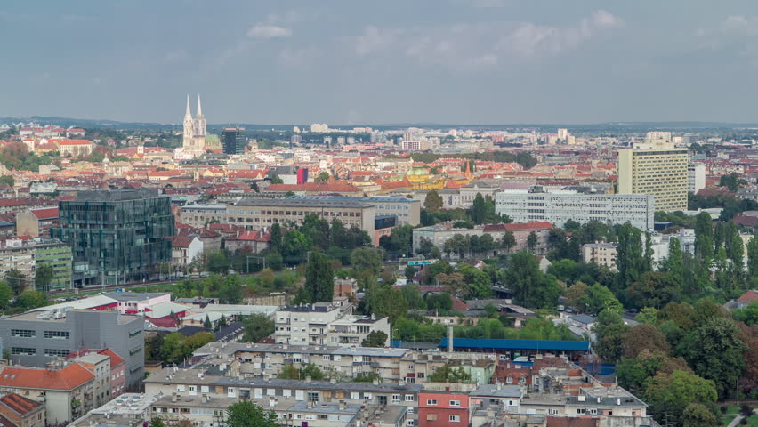 Panorama of the city center timelapse, Zagreb capital of Croatia, with modern and historic buildings, museums in the distance. Top aerial view from skyscraper