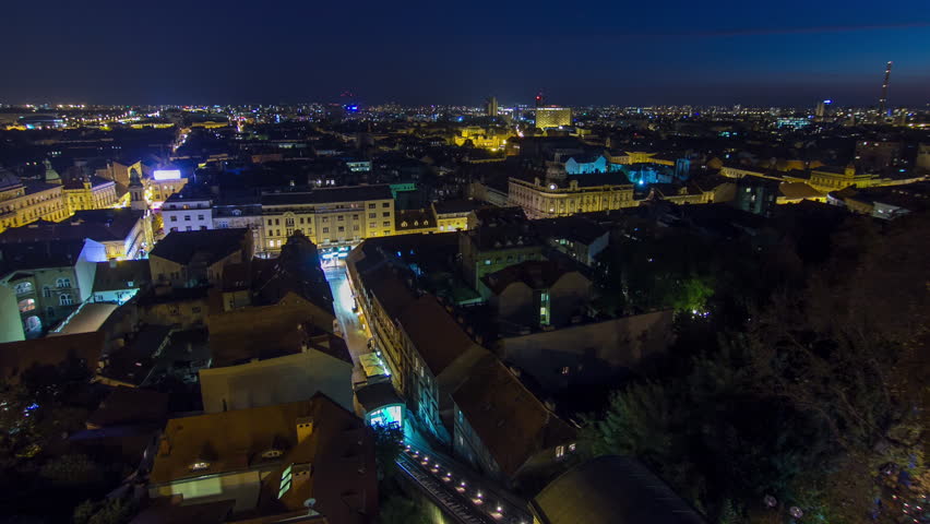 Old town of Zagreb at night timelapse. Zagreb, Croatia. Top panoramic view from Kula Lotrscak tower viewpoint with illuminated streets