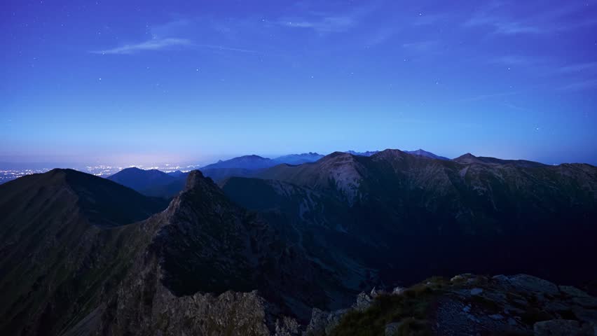 Recurring twilight in a high mountain country. Mountain peaks and stars in the sky. video loop
