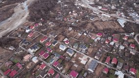 Aerial drone video of residential district with houses, buildings, streets and homes with photovoltaic solar panels. Modern houses with renewable sources of energy in suburban neighborhood.