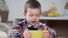 Little Boy Holds Phone, Plays Mobile Games, Watches Videos and Social Media