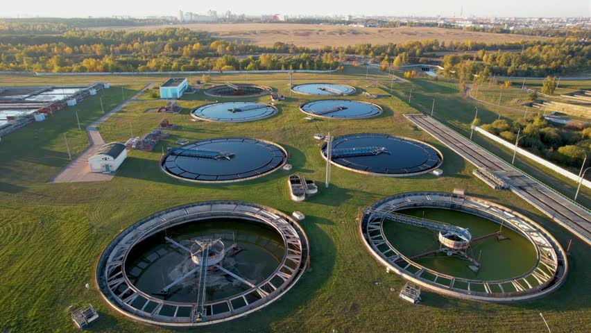 Sewage treatment plant Grey water recycling. Waste management Aerial top view of round polls tank | Shutterstock HD Video #1100259423