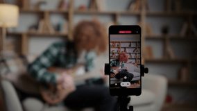 Red-haired curly-haired man sits on the sofa and plays the guitar - Powered by Shutterstock - Get 15% off with code: PIKWIZARD15
