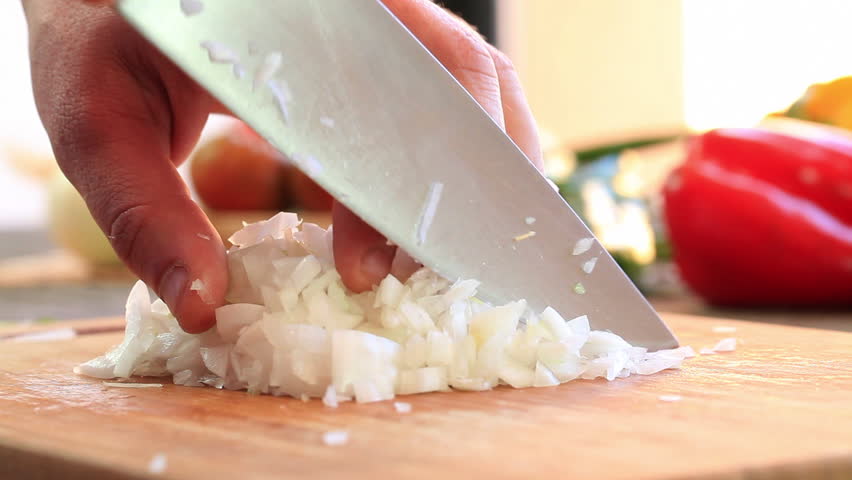 Chef chopping onions in the kitchen