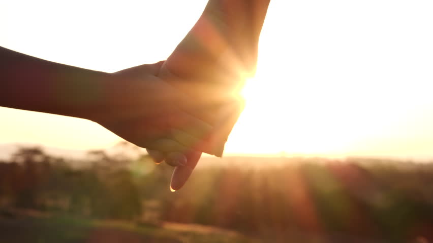 Mother and child daughter hands joining, holding together silhouette sun rays, sunset on natural background, 4K. Romantic moment between mom and daughter. Concept of Happy Family, Love, Valentines Day | Shutterstock HD Video #1100266527