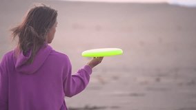 Frisbee tricks at the beach. Cute woman d do tricks with frisbee in slow motion spinning it in a close-up view by the seashore - Powered by Shutterstock - Get 15% off with code: PIKWIZARD15