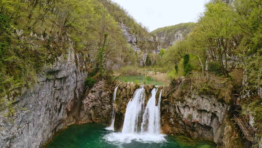 Aerial view Plitvice lakes national park UNESCO lake in Croatia. Drone copter shooting from above Croatian waterfall mountains river trees forest beautiful nature of Europe green landscape tourism