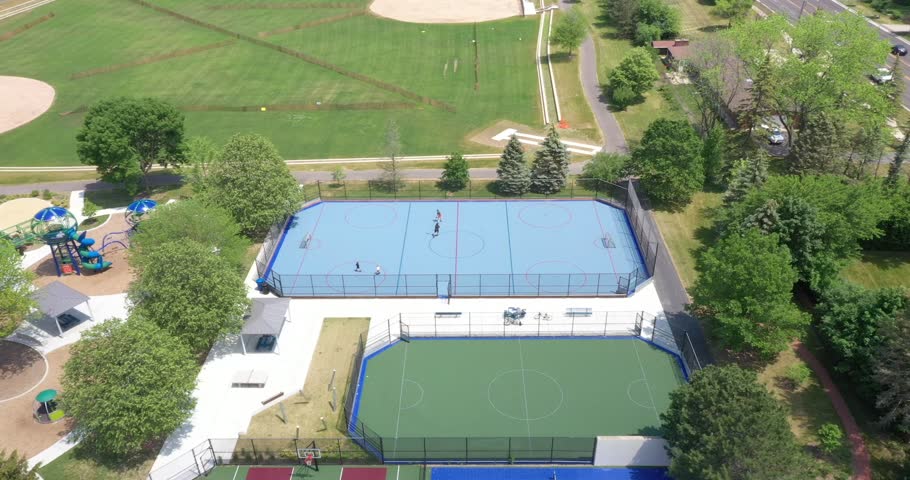 Suburban park with tennis, pickleball and basketball courts and a hockey rink. 