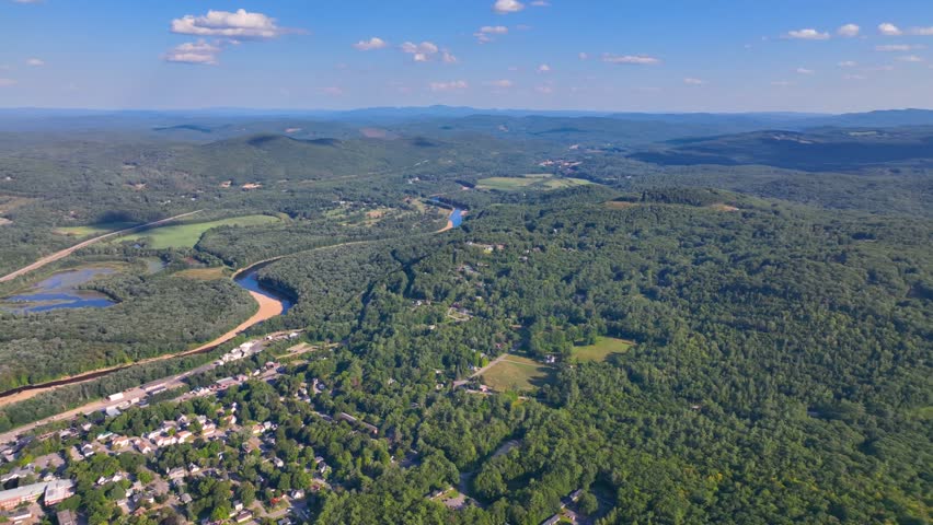 Plymouth State University and Pemigewasset River aerial view with White Mountain National Forest at the background in summer in historic town center of Plymouth, New Hampshire NH, USA. 