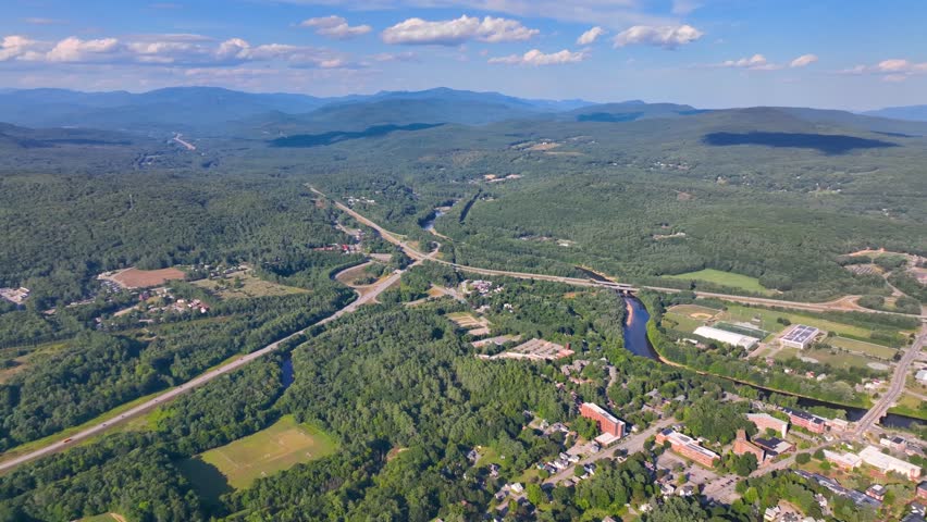 Plymouth State University and Pemigewasset River aerial view with White Mountain National Forest at the background in summer in historic town center of Plymouth, New Hampshire NH, USA. 