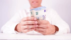 Man counting pack of twenties 500 euros 2 notes 20EUR banknotes footage. Money concept. Wealth, financial things concept looped footage. - Powered by Shutterstock - Get 15% off with code: PIKWIZARD15