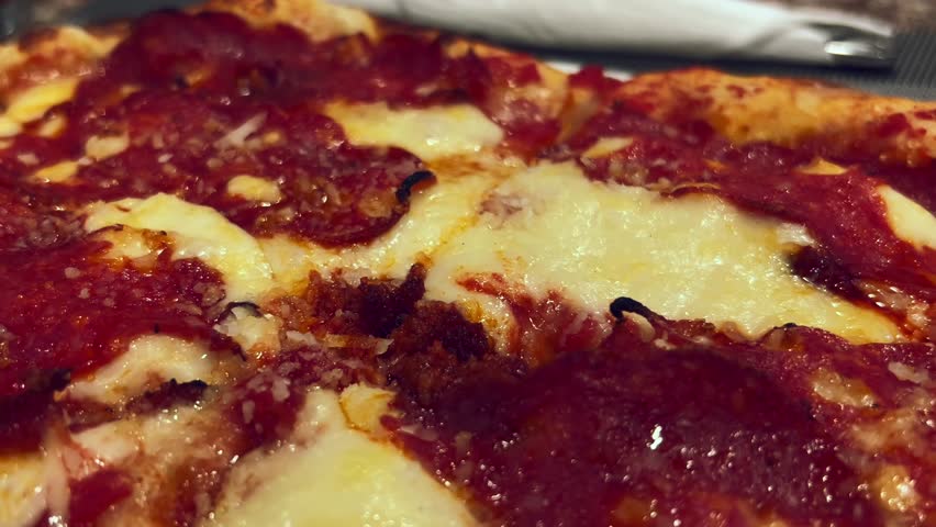Closeup of diavola pizza in restaurant, hot spicy salami and mozzarella cheers