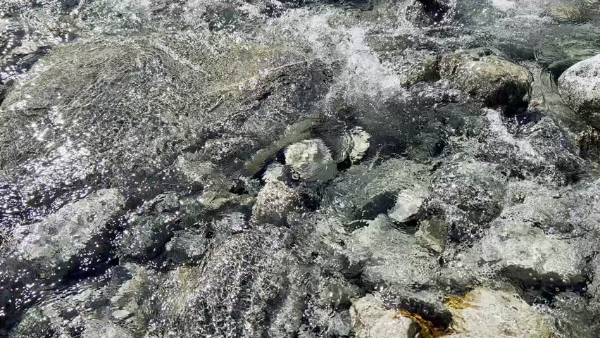 Crystal clear stream rushing down from a waterfall in Angeles National Forest