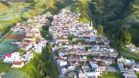 Aerial view of beautiful village called Nepal Van Java on the slope of mountain. Colorful house of village. Sumbing Mountain - Indonesia