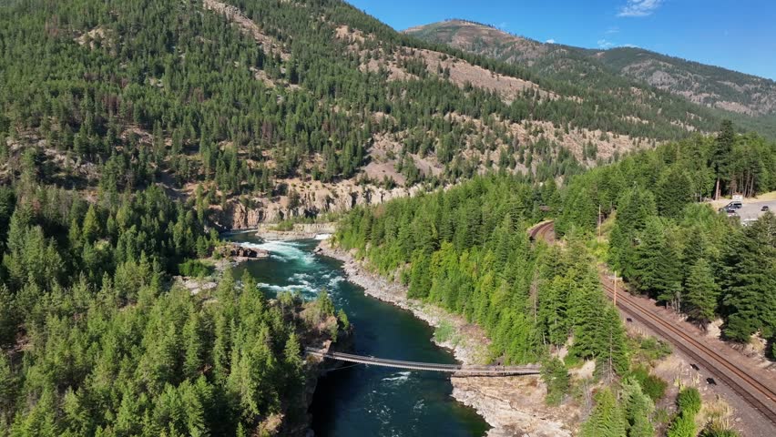 Aerial View Of Kootenai Falls Suspension Bridge Spanning Across Kootenay River In Libby, Montana, USA.