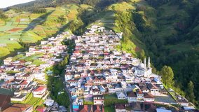 Aerial view of beautiful scenery of village on the slope of mountain with view of terraced houses. Nepal Van Java, Indonesia