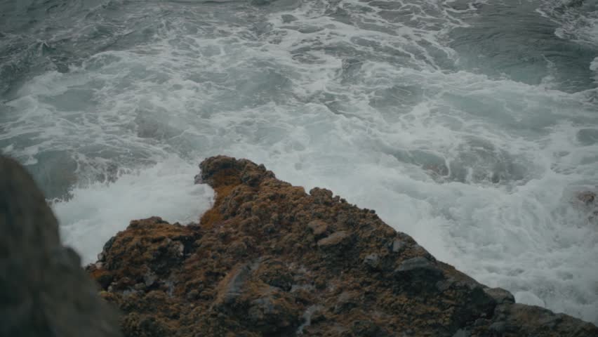 Waves hitting rocks on beach | Shutterstock HD Video #1100285967