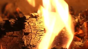 Isolated flame coming from a wood log. This fireplace video is great if you need a close up shot of a yellow and orange flame. The amber color is warming and relaxing. Shot in full high definition.