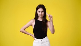 4k video of one girl who responds negatively to something over yellow background.
