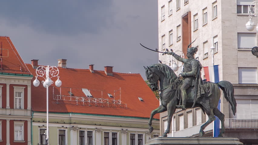 Central city square (Trg bana Jelacica) timelapse and Ban Jelacic monument in Zagreb, Croatia. The oldest standing buildings with red roofs