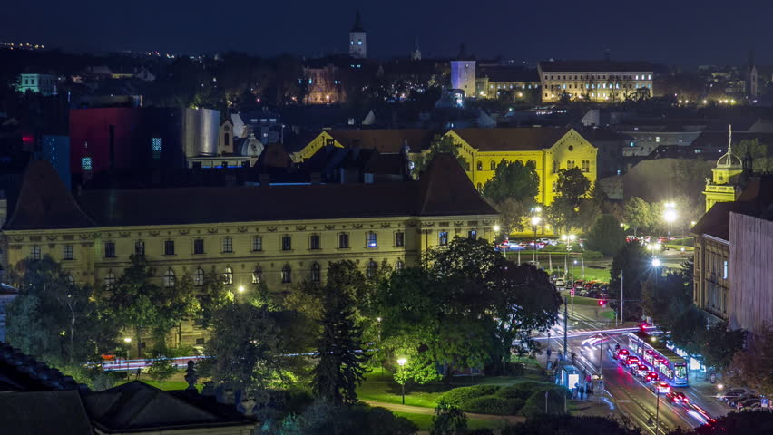 Panorama of the city center night timelapse shoot from top of skyscraper with aerial view to the intersection in front of national theater and museum in Zagreb, Croatia. Traffic on the road
