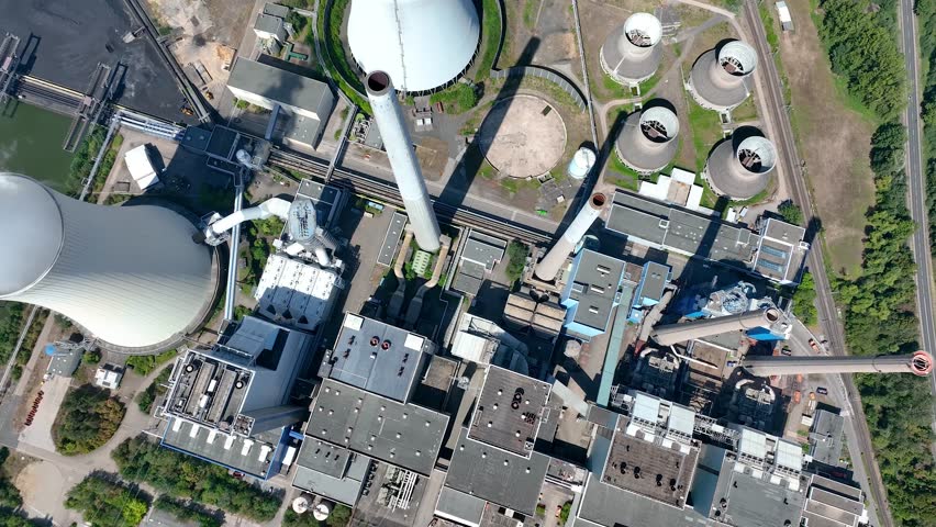 Aerial view of chimneys of power plant, an industrial district. Modern large thermal power plant in Germany, Europa. Generation through coal switched over to natural gas