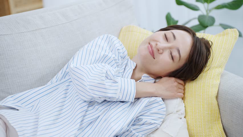 Woman sleeping on the sofa | Shutterstock HD Video #1100296035