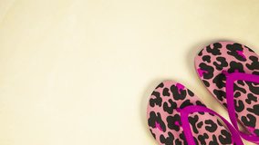 Bright women's flip flops on a colorful yellow background moving from left to right top view, pink panther pattern spring,summer concept close up - Powered by Shutterstock - Get 15% off with code: PIKWIZARD15