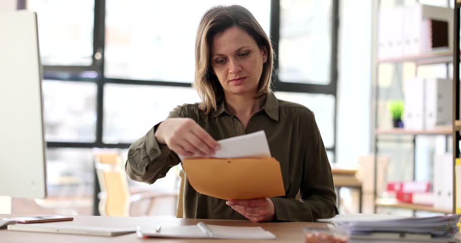 Business woman working in office opens reading letter on desktop Royalty-Free Stock Footage #1100299913